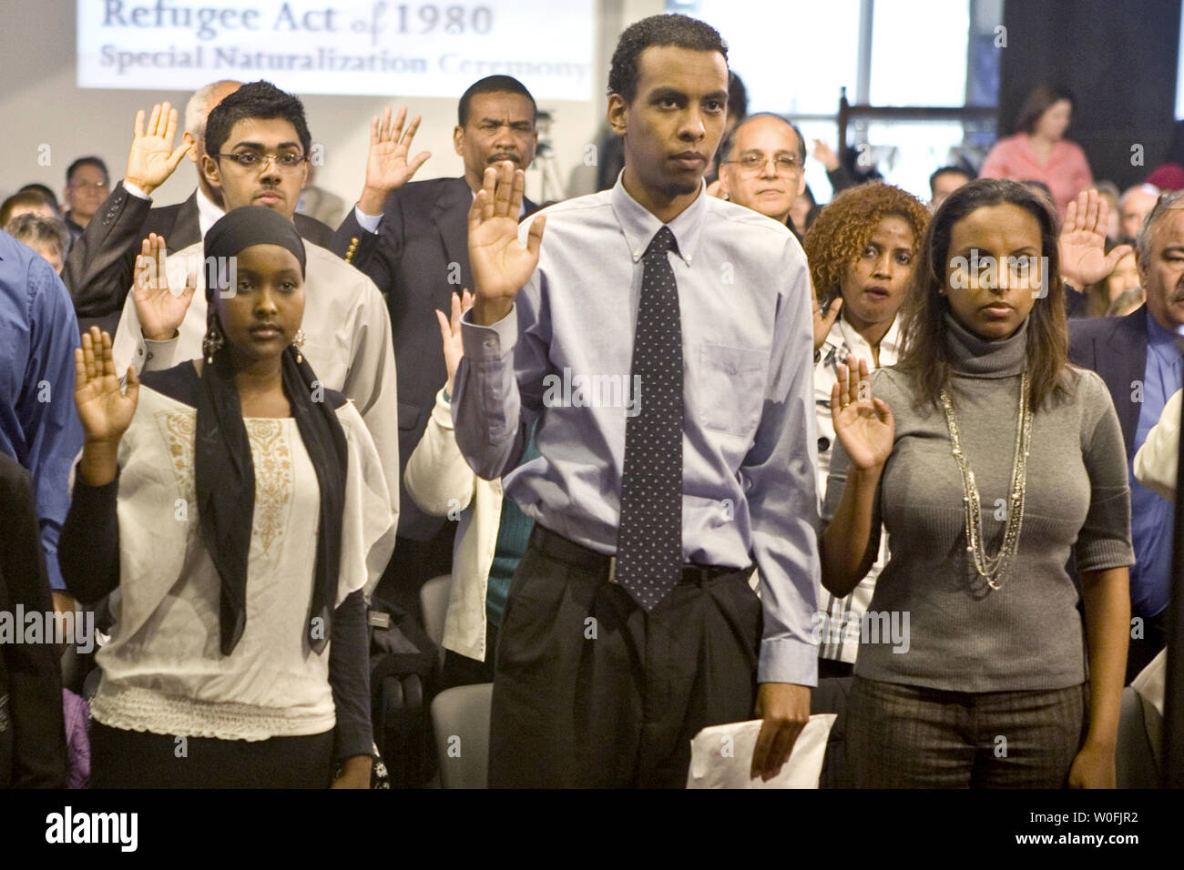 Yasmin Said from Somalia, Robel Tsehai from Ethiopia, and Bethel Tsehai from Ethiopia (L-R) take the Oath of Allegiance during a naturalization ceremony commemorating the 30th anniversary of the Refugee Resettlement Act of 1980. 27 new citizens from Egypt, Ethiopia, Iran, Pakistan, Philippines, Sierra Leone, Somalia, Sudan and Vietnam took the Oath of Allegiance in Washington on March 30, 2010.      UPI/Madeline Marshall Stock Photo
