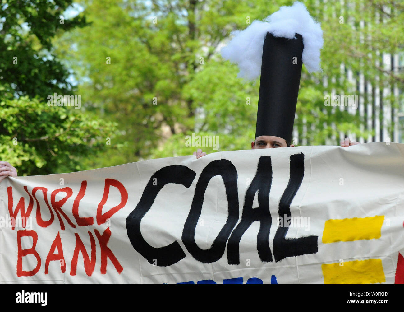 A Protestor Dressed As A Smoke Stack Participates In A Rally Held