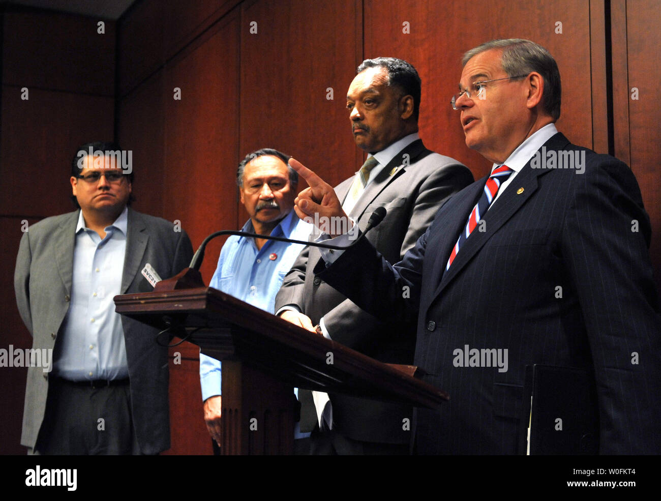 Sen. Robert Menendez (D-NJ) (R) delivers remarks at a press conference introducing the Protect Our Workers from Exploitation and Retaliation (POWER) Act in Washington on April 14, 2010. Menendez was joined by, right to left, Rev. Jesse Jackson, Arturo Rodriguez, President of United Farm Workers of America, and Daniel Castellanos, Organizer of Alliance of Guestworkers for Dignity.  UPI/Kevin Dietsch Stock Photo