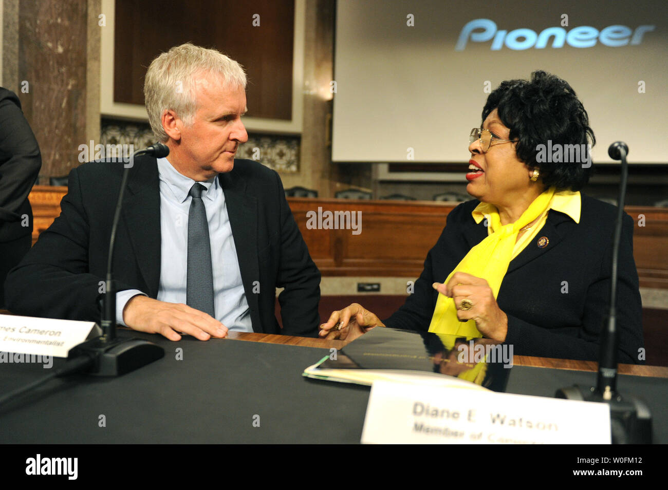 Filmmaker James Cameron and Rep. Diane Watson (D-CA) talk prior to a panel discussion on global environmental issue on Capitol Hill in Washington on April 15, 2010.   UPI/Kevin Dietsch Stock Photo