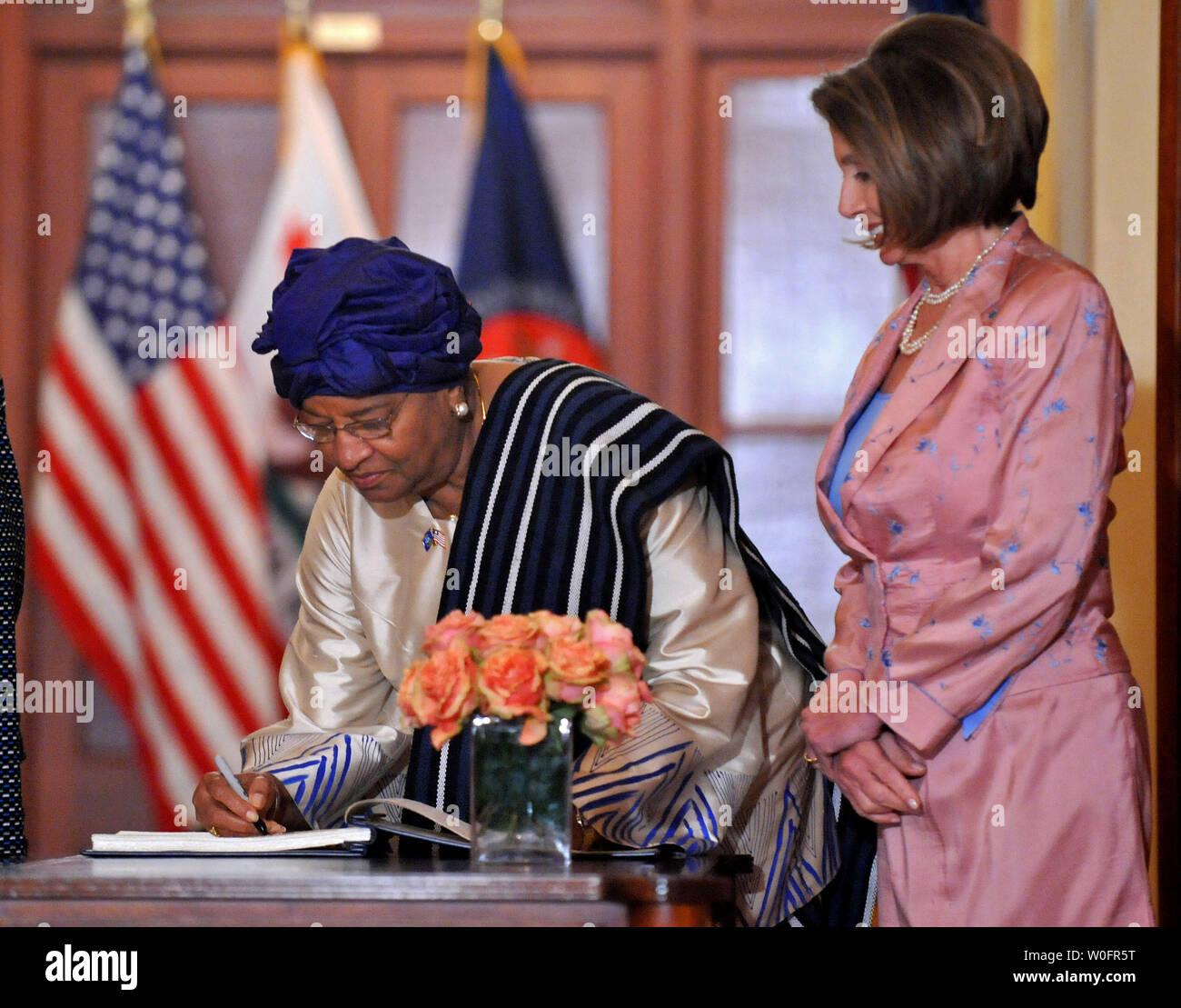 Liberian President Ellen Johnson Sirleaf (L) signs a guest book as Speaker of the House Nancy Pelosi (D-CA) stands by prior to a meeting in the U.S. Capitol Building in Washington on May 25, 2010.  UPI/Kevin Dietsch Stock Photo