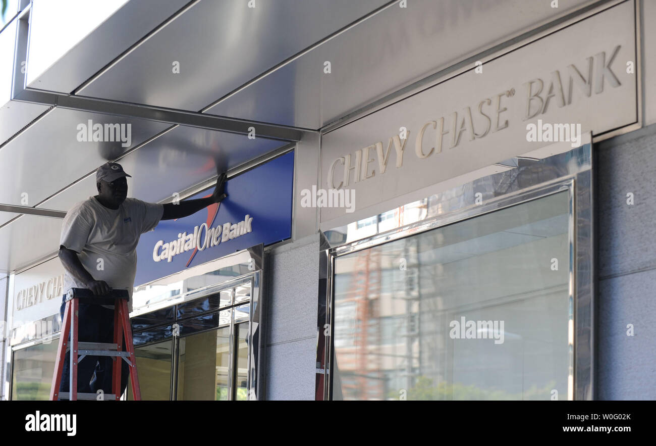 A Worker Installs A Capital One Bank Sign At An Old Chevy Chase