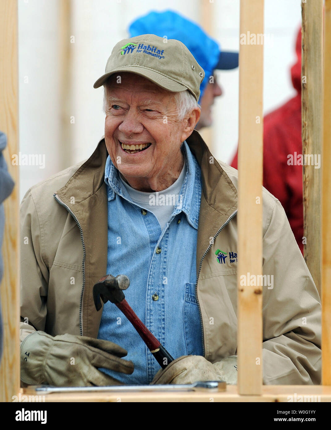 Former President Jimmy Carter works on a house as part of the Habitat