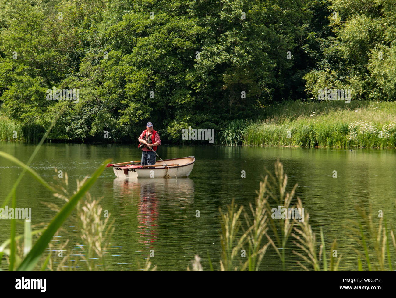 Man standing in a boat hi-res stock photography and images - Alamy