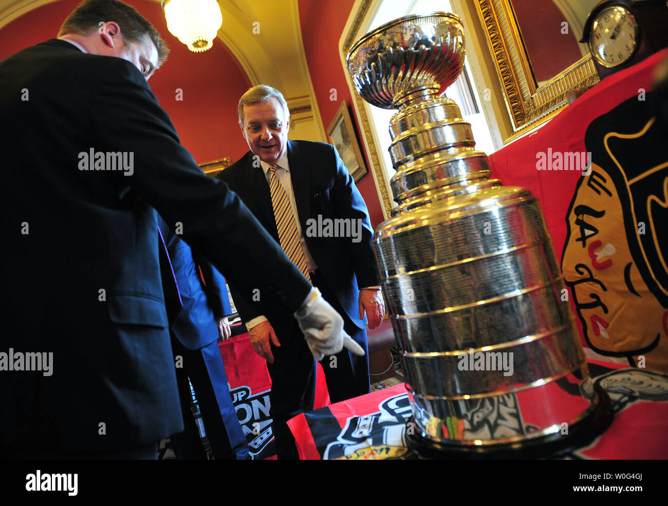 Mike Bolt (L), the keeper of the Stanley Cup, shows Sen. Richard Durbin (D-IL) where the Chicago Blackhawks name is on the Stanley Cup during a visit to Durbin's office on Capitol Hill in Washington on December 13, 2010.  The Chicago Blackhawks defeated the Philadelphia Flyers 4 games to 2 games to win the 2010 Stanley Cup championship.  UPI/Kevin Dietsch Stock Photo
