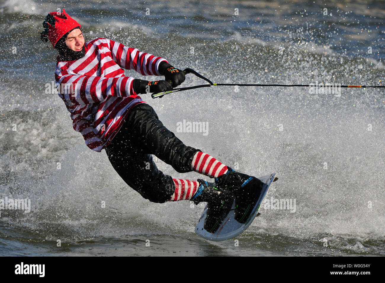 A wakeboarder dressed as an elf performs during the 25th annual Water-Skiing Santa show on the Potomac River at the National Harbor in Maryland on December 24, 2010.  UPI/Kevin Dietsch Stock Photo