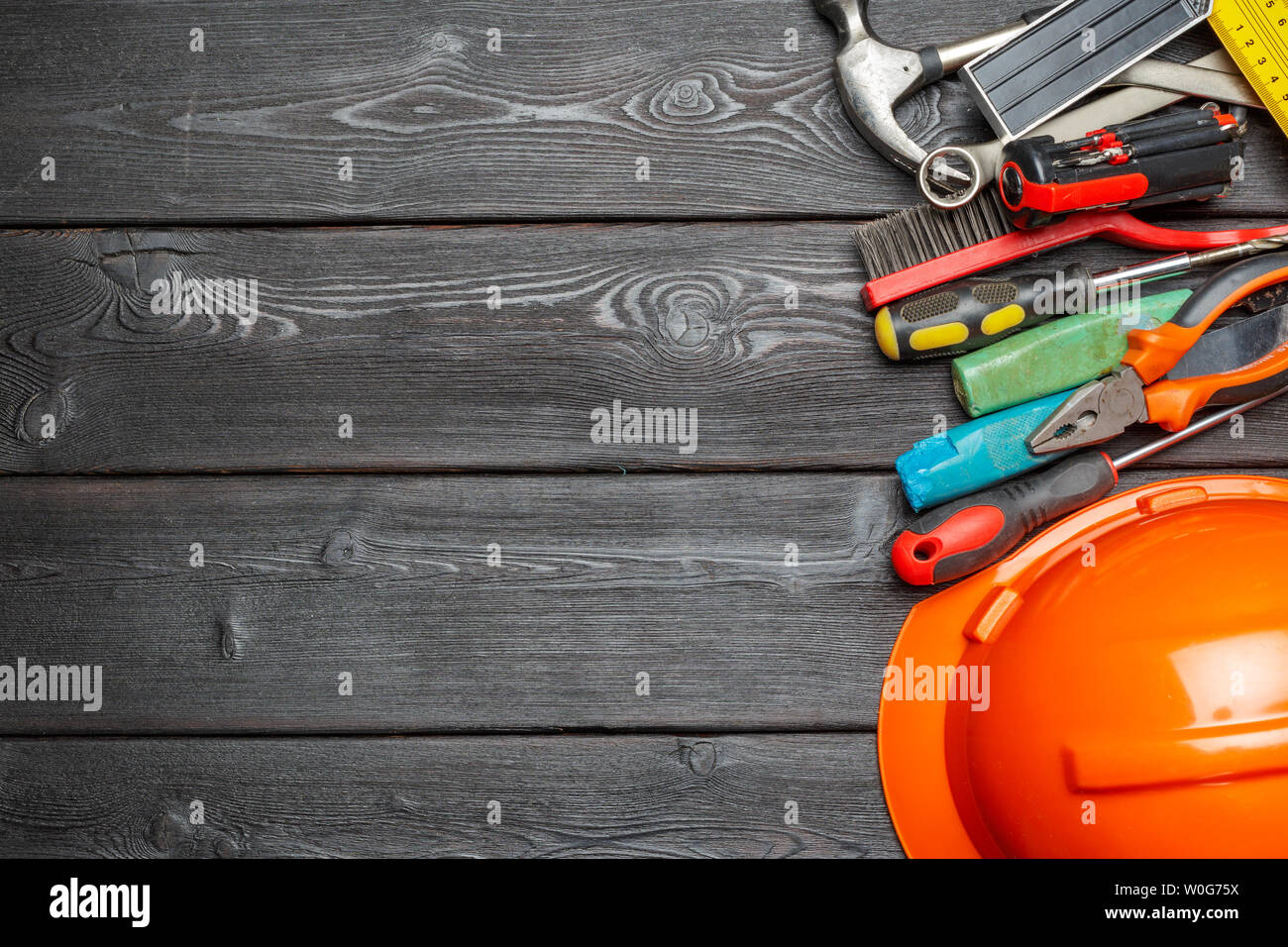 Assorted work tools on wooden table Stock Photo
