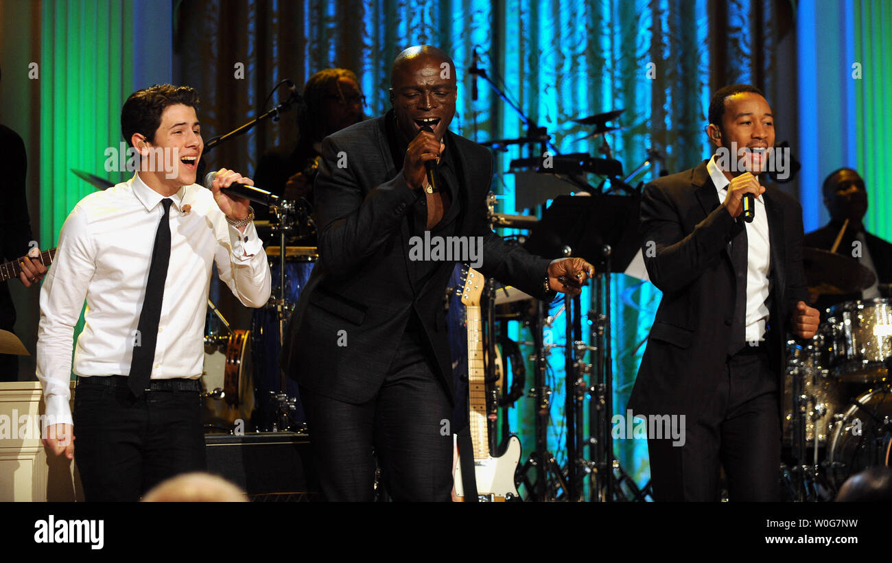 Nick Jonas, Seal and John Legend (L to R) perform during 