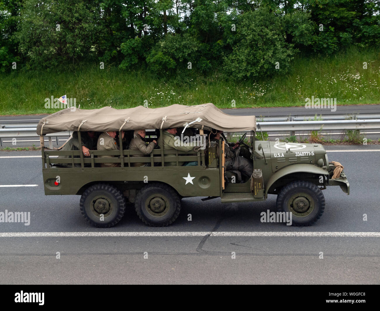 A vintage army vehicle on a road in Normandy en route to a commemoration of D-Day Stock Photo