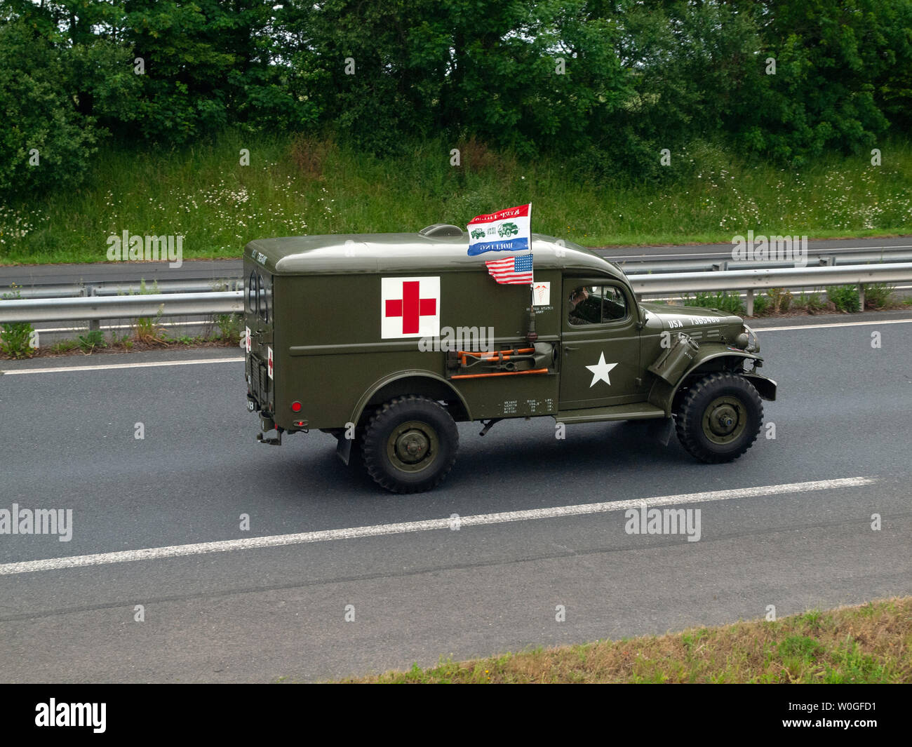 A vintage army vehicle on a road in Normandy en route to a commemoration of D-Day Stock Photo