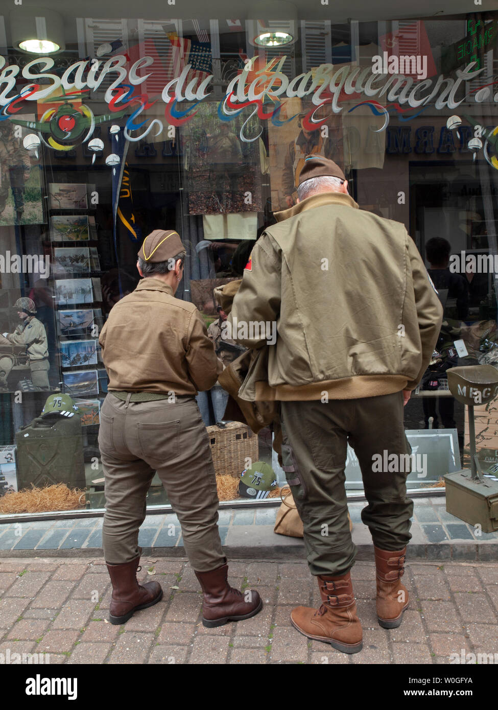 Looking in the window of an army surplus shop in Normandy Stock Photo