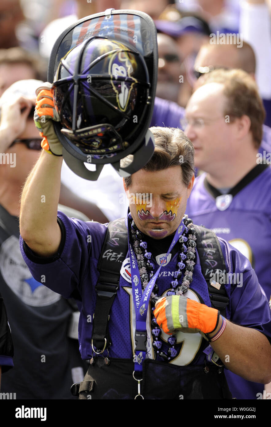 A Ravens fan in firefighter gear prays before the Pittsburgh Steelers play  the Baltimore Ravens at M&T Bank Stadium in Baltimore, Maryland on  September 11, 2011. UPI/Roger L. Wollenberg Stock Photo - Alamy