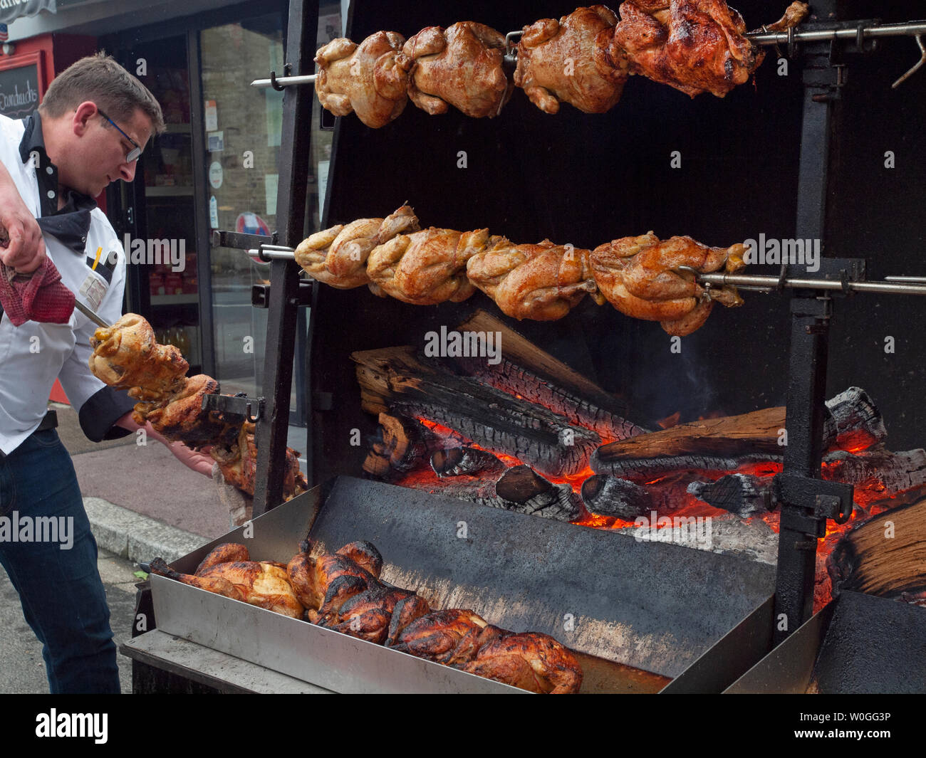 Roasting chickens outside in a Normandy village Stock Photo