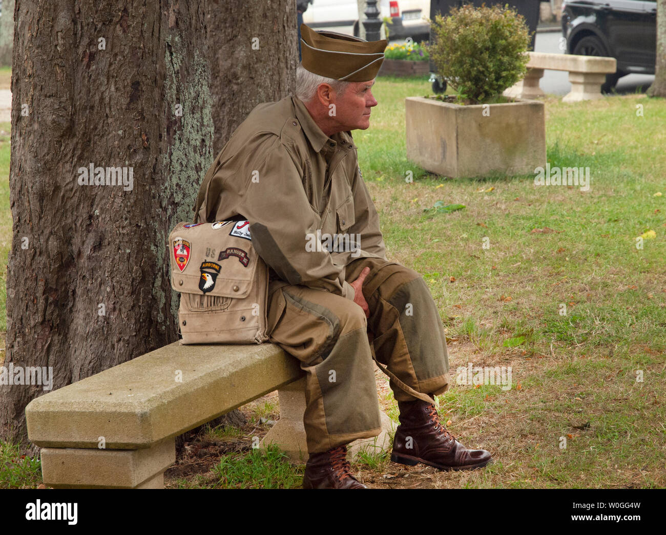 An old American soldier sits and thinks in a Normandy village during the D-Day commemorations Stock Photo