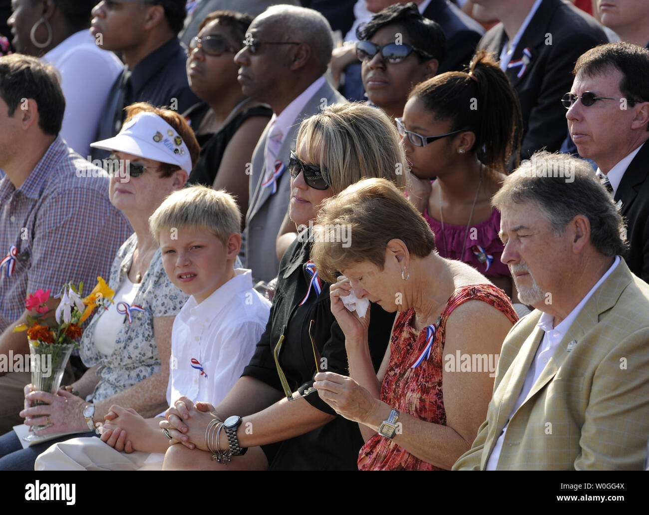 Patricia Falllon (C) of Fredericksburg, Virginia, who lost her daughter, Navy SK3 Jamie Fallon during the Pentagon attack, wipes tears during the 10th anniversary ceremony, September 11, 2011, in Arlington, Virginia.  On September 1, 2001, high-jacked American Airlines flight 77 crashed into the Pentagon, killing all 64 passengers on board and 125 in the Pentagon.   UPI/Mike Theiler Stock Photo