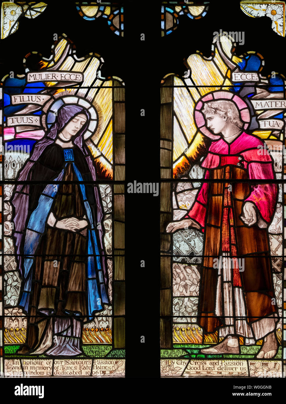 Christopher Whall's 1906 depiction of Mary and John hearing some of the final words of Jesus on the cross, St. Margaret's Church, Bagendon, UK Stock Photo