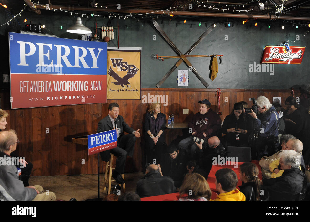 Republican 2012 presidential candidate and Texas Gov. Rick Perry responds to a question as his wife Anita (C) listens along with supporters during a campaign stop at The Fainting Goat Bar and Grill in Waverly, Iowa, December 30, 2011, in advance of Iowa's first-in-the-nation caucuses, January 3,2012.    UPI/Mike Theiler Stock Photo