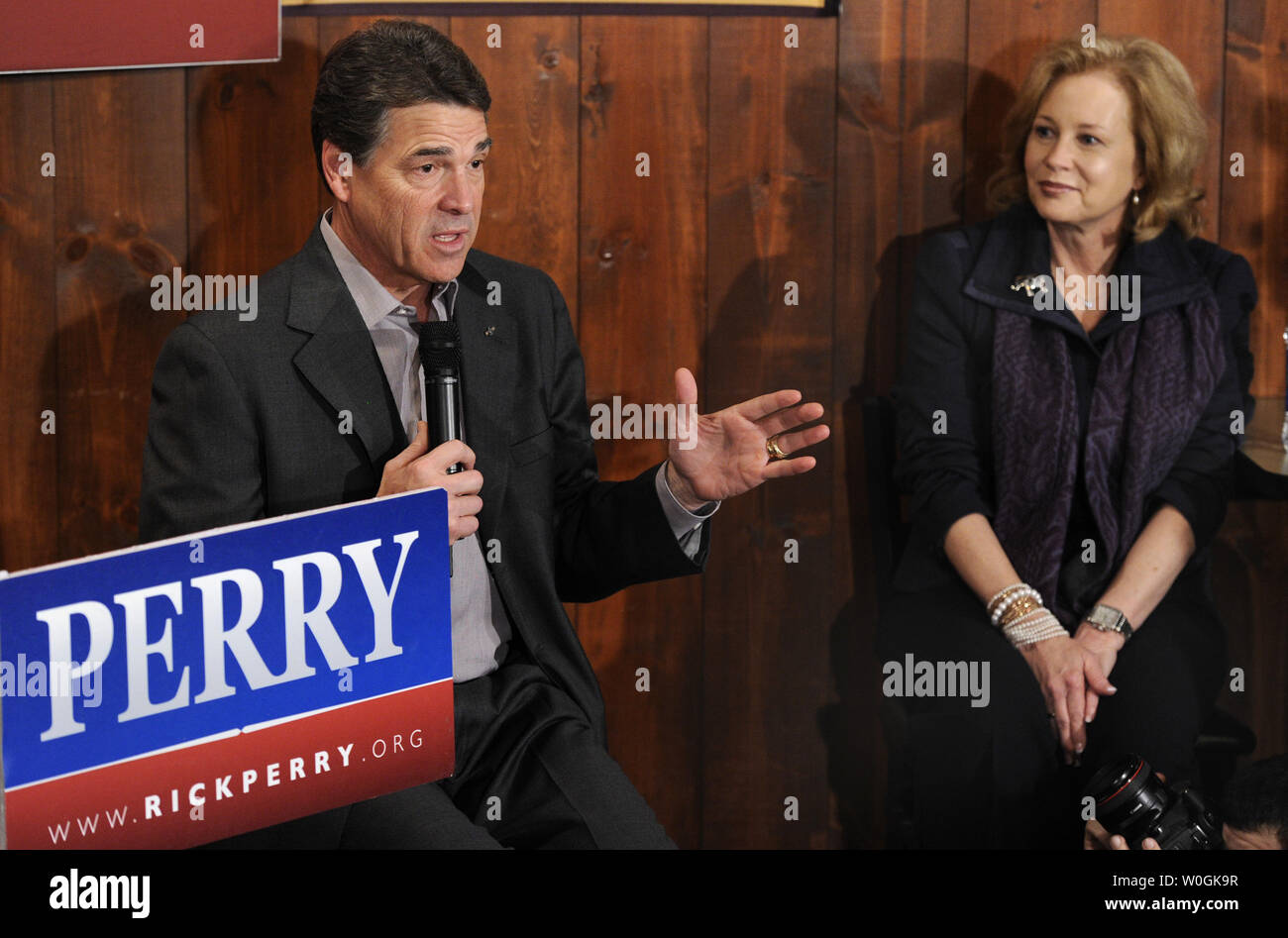 Republican 2012 presidential candidate and Texas Gov. Rick Perry responds to a question as his wife Anita (R) listens along with supporters during a campaign stop at The Fainting Goat Bar and Grill in Waverly, Iowa, December 30, 2011, in advance of Iowa's first-in-the-nation caucuses, January 3, 2012.    UPI/Mike Theiler Stock Photo