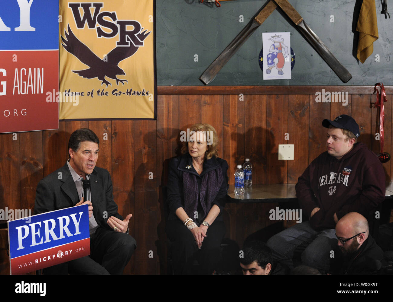 Republican 2012 presidential candidate and Texas Gov. Rick Perry responds to a quesstion as his wife Anita and Robert Loewen of Minneapolis, Minnesota, listen during a campaign stop at The Fainting Goat Bar and Grill in Waverly, Iowa, December 30, 2011, in advance of Iowa's first-in-the-nation caucuses, January 3,2012.    UPI/Mike Theiler Stock Photo
