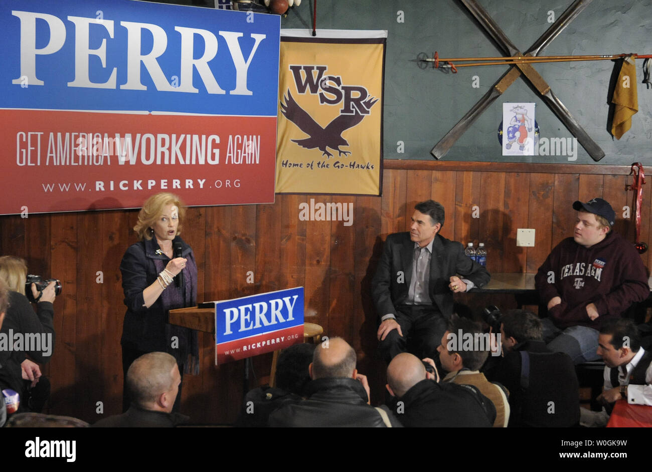 Republican 2012 presidential candidate and Texas Gov. Rick Perry (seated,C) listens as he is introduced by his wife Anita during a campaign stop at The Fainting Goat Bar and Grill in Waverly, Iowa, December 30, 2011, in advance of Iowa's first-in-the-nation caucuses, January 3, 2012.    UPI/Mike Theiler Stock Photo