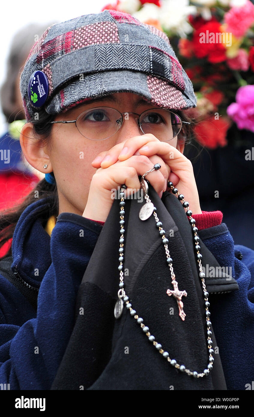 A woman prays in front of the United States Supreme Court during a rally against abortion a day before the Court will take up arguments on the constitutionality of President Obama's health care reform bill, in Washington, D.C. on March 25, 2012.   UPI/Kevin Dietsch Stock Photo
