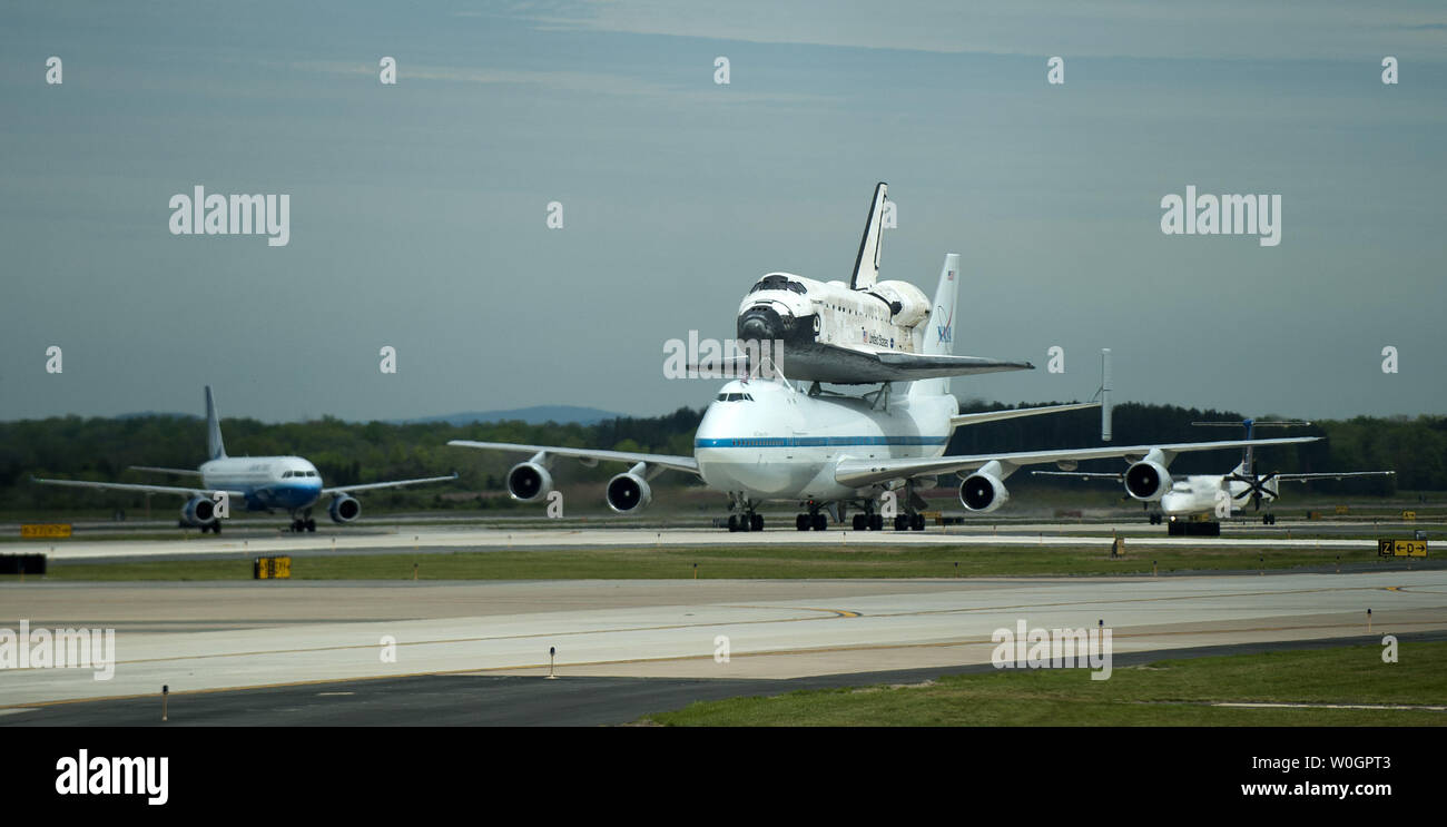 Space Shuttle Discovery, riding atop NASA's 747 shuttle carrier aircraft, taxis on the runway after landing at Dulles International Airport in Chantilly, Virginia on April 17, 2012.  Discovery, which ended it's last mission on March 9, 2011, is being put on permanent display at the Smithsonian's National Air and Space MuseumÍs Udvar-Hazy Center in Chantily, Virginia.  UPI/Kevin Dietsch Stock Photo
