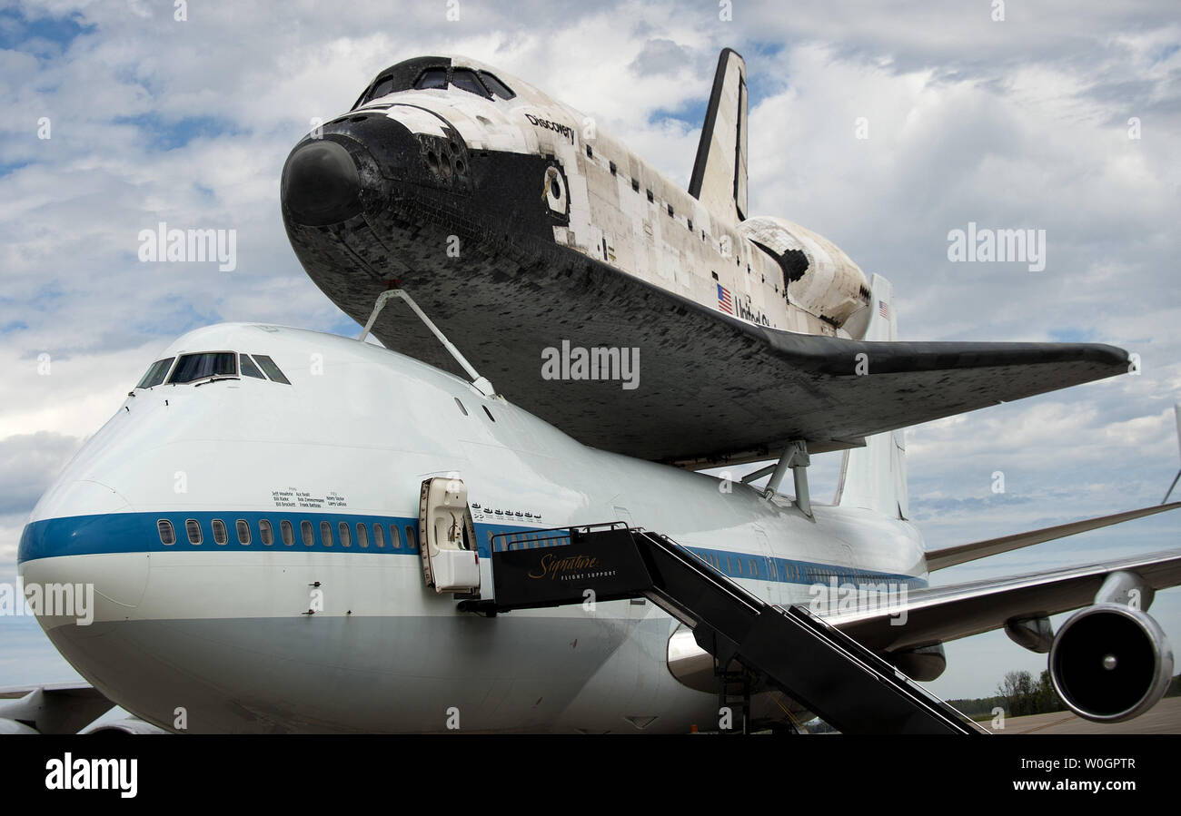 The Space Shuttle Discovery sits on top of NASA's 747 shuttle carrier aircraft after it landed at Dulles International Airport in Chantilly, Virginia on April 17, 2012.  Discovery, which ended it's last mission on March 9, 2011, is being put on permanent display at the Smithsonian's National Air and Space Museum's Udvar-Hazy Center in Chantilly, Virginia.  UPI/Kevin Dietsch Stock Photo