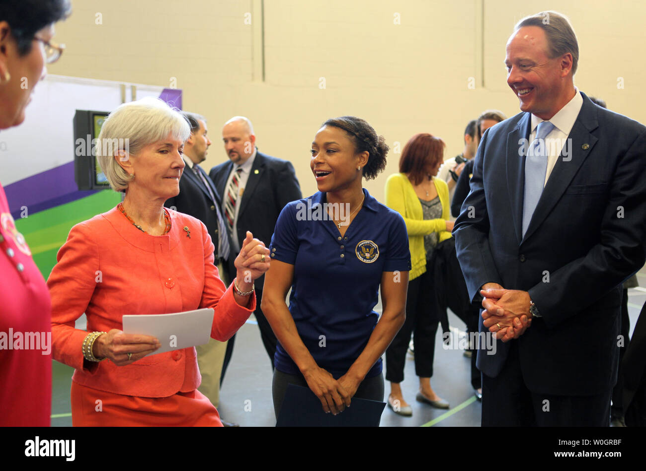 Health and Human Services Secretary Kathleen Sebelius talks with Olympic gymnast Dominique Dawes (C) and Michael Gallagher, ESA CEO, during the President's Council on Fitness, Sports and Nutrition active video game demonstration event with students from Walker Jones Education Campus in Washington DC on April 30, 2012.    UPI/Molly Riley Stock Photo