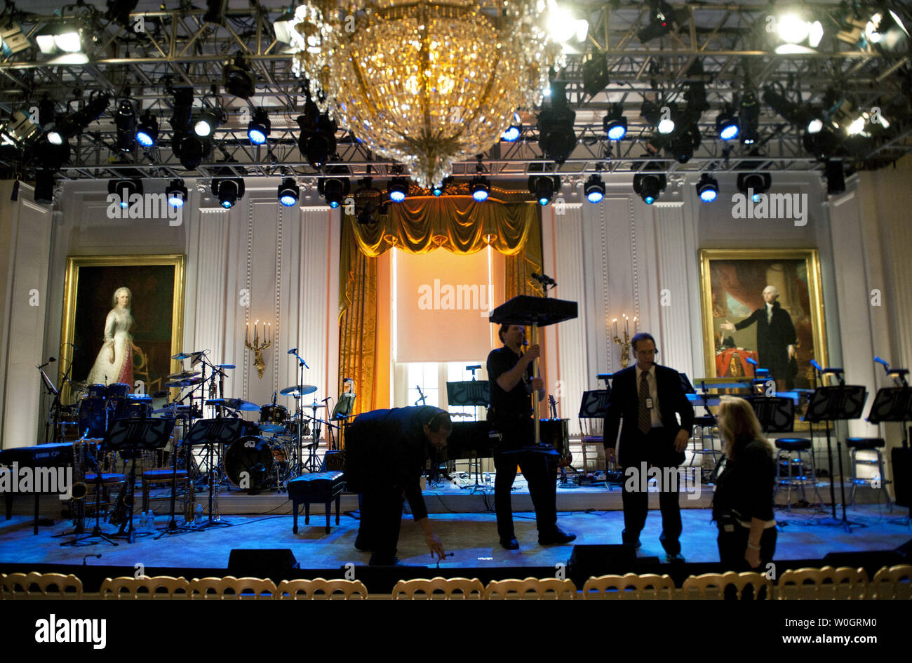 White House staff prepare the East Room for a concert with Burt