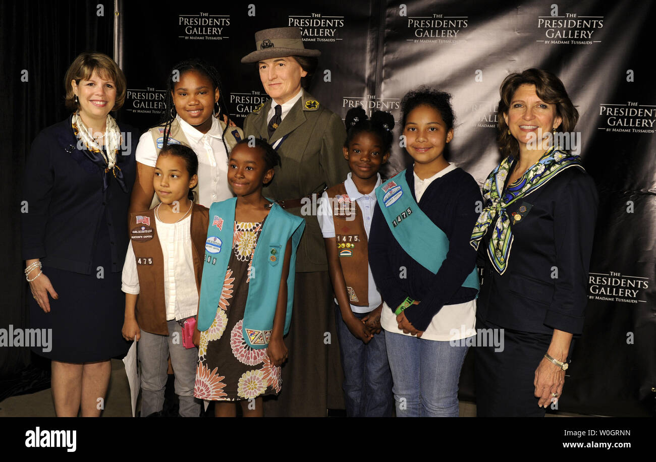 Girl Scout Council of the Nation's Capitol President Diane Tipton (L) and GSCNC CEO Lidia Soto-Harmon (R) pose with area Girl Scouts at the unveiling of the Madame Tussauds Museum's wax figure of Girl Scout founder Juliette Gordon Low, May 9, 2012, in Washington, DC. The Girl Scouts are celebrating the organization's 100th anniversary this year.              UPI/Mike Theiler Stock Photo