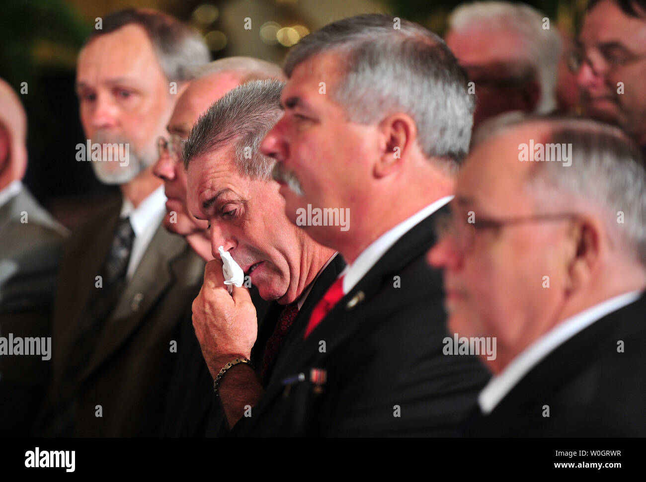 A member of Bravo company wipes tears from his face as U.S. President Barack Obama delivers remarks during the Medal of Honor ceremony for his former comrade U.S. Army Specialist Leslie H. Sabo, Jr., in the East Room of the White House in Washington, DC,on May 16, 2012. Sabo was awarded the metal for his extreme acts of bravery while fighting in Cambodia as part of the Vietnam War. Sabo picked up a live enemy grenade and threw it back while shielding a wounded comrade with his own body. He then charged an enemy position, throwing another grenade into an enemy bunker killing himself in the blas Stock Photo