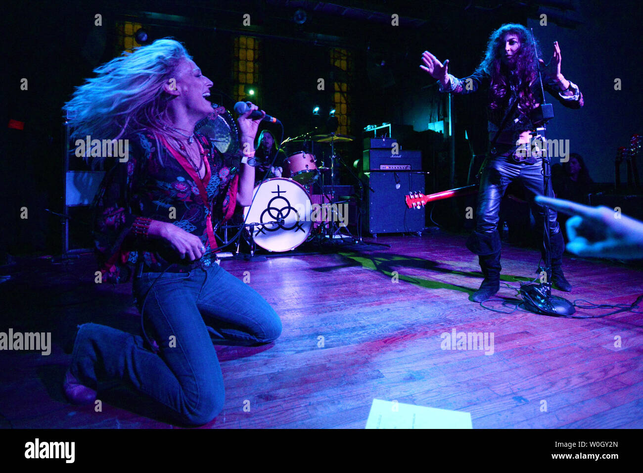 Lead singer Shannon Conley belts out the Led Zeppelin tune 'Whole Lotta Love' assisted by lead guitarist Steph Paynes (R) and drummer Leesa Harrington-Squyres during a performance by the all-girl Lez Zeppelin band at the Altar Bar, a converted church, in Pittsburgh, Pennsylvania on November 10, 2012.  The Led Zeppelin movie 'Celebration Day' is released on Blu-ray and other home formats on November 19, 2012, while their live music lives on with popular groups like Lez Zeppelin in bars and theaters across America.  Not seen is Megan Thomas.   UPI/Pat Benic Stock Photo