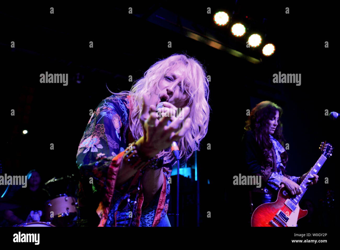 Lead singer Shannon Conley belts out the Led Zeppelin tune 'Whole Lotta Love' assisted by lead guitarist Steph Paynes and drummer Leesa Harrington-Squyres during a performance by the all-girl Lez Zeppelin band at the Altar Bar, a converted church, in Pittsburgh, Pennsylvania on November 10, 2012.  The Led Zeppelin movie 'Celebration Day' is released on Blu-ray and other home formats on November 19, 2012, while their live music lives on with popular groups like Lez Zeppelin in bars and theaters across America.  Not seen is Megan Thomas.   UPI/Pat Benic Stock Photo