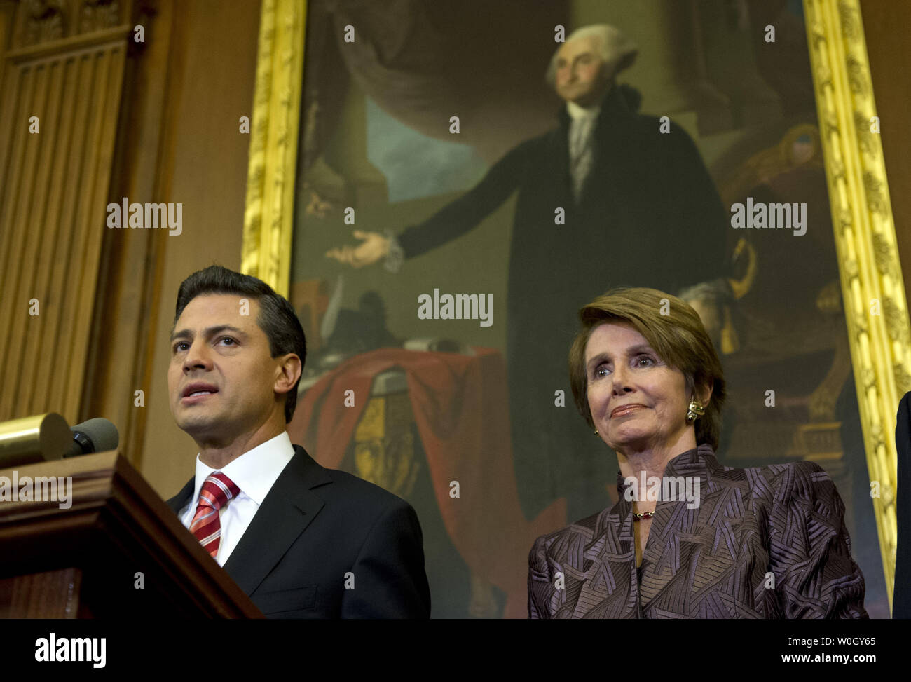 Mexican President-elect Enrique Pena Nieto speaks alongside House Minority Leader Nancy Pelosi (D-CA) during a media availability on Capitol Hill in Washington, DC on November 27, 2012.  UPI/Kevin Dietsch Stock Photo