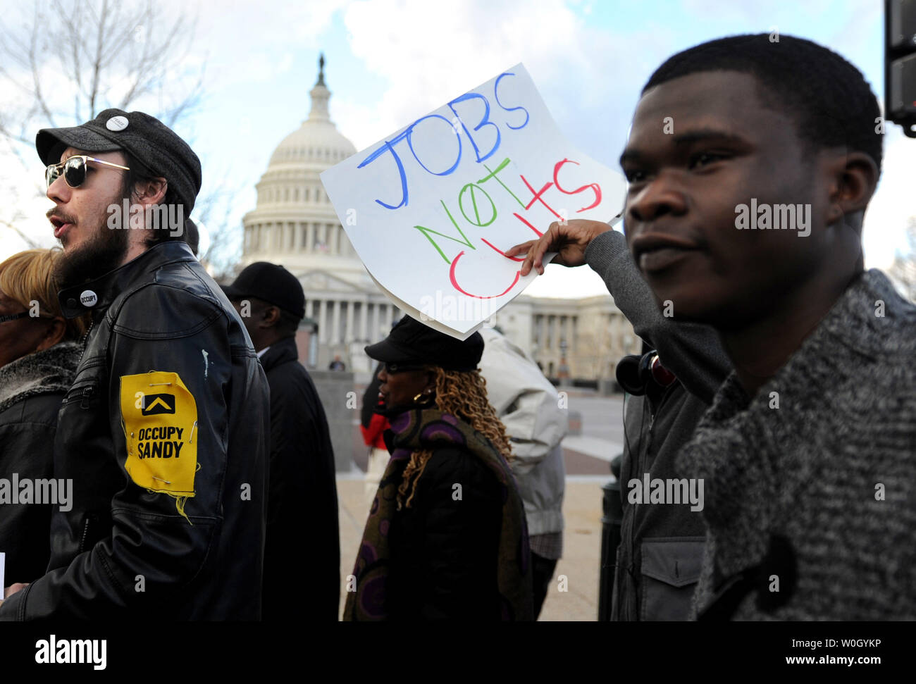 People participate in a demonstration against the fiscal cliff showdown and the possible cuts to Medicare on Capitol Hill in Washington, DC on December 18, 2012.  UPI/Kevin Dietsch Stock Photo