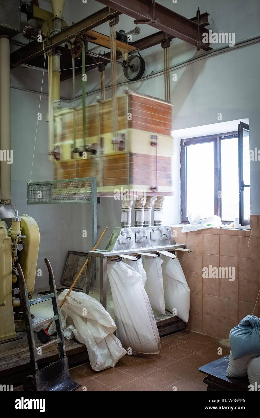 NOCI, ITALY - SEPTEMBER 29, 2018: Wheat milling process in an electrically-powered old mill Stock Photo