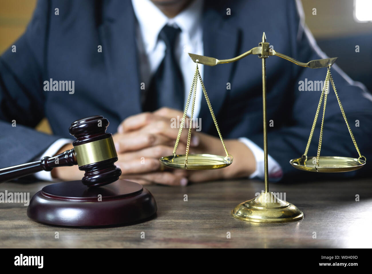 Legal law, advice and justice concept, male counseling lawyer or notary working on a documents and contract papers of the important case and wooden ga Stock Photo