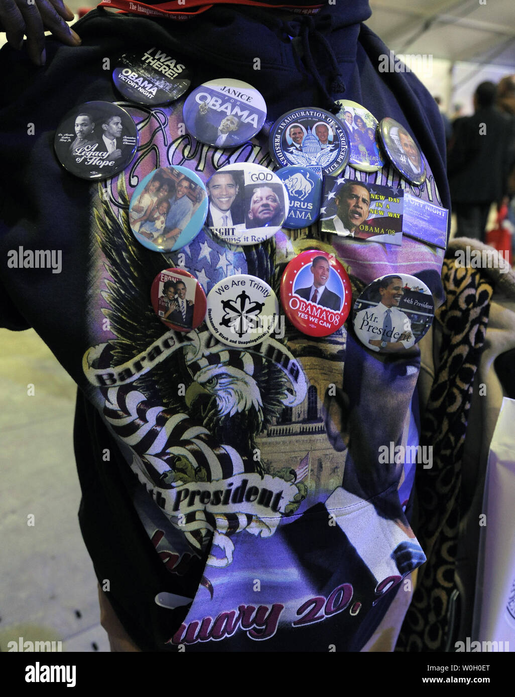 A supporter of US President Barack Obama wears multiple buttons at a gathering on the National Mall for the National Day of Service, in Washington, DC, January 19, 2013. The National Day of Service, begun by President Obama and the first family, is a legacy of the Rev. Martin Luther King, Jr,. whose holiday on January 21, will coincide with the 57th Inauguration.  .       UPI/Mike Theiler Stock Photo