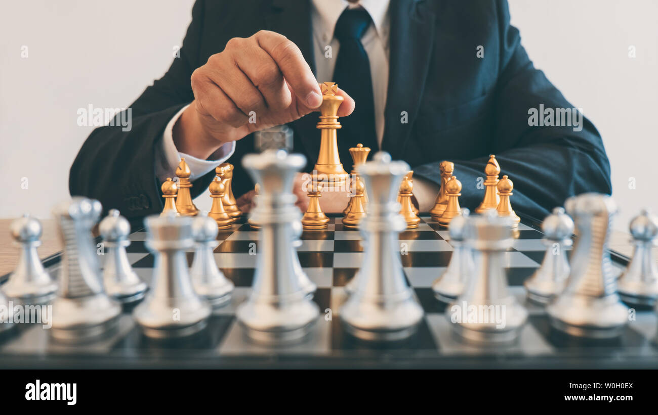 Businessman leadership playing chess and thinking strategy plan about crash overthrow the opposite team and development analyze for successful of corp Stock Photo