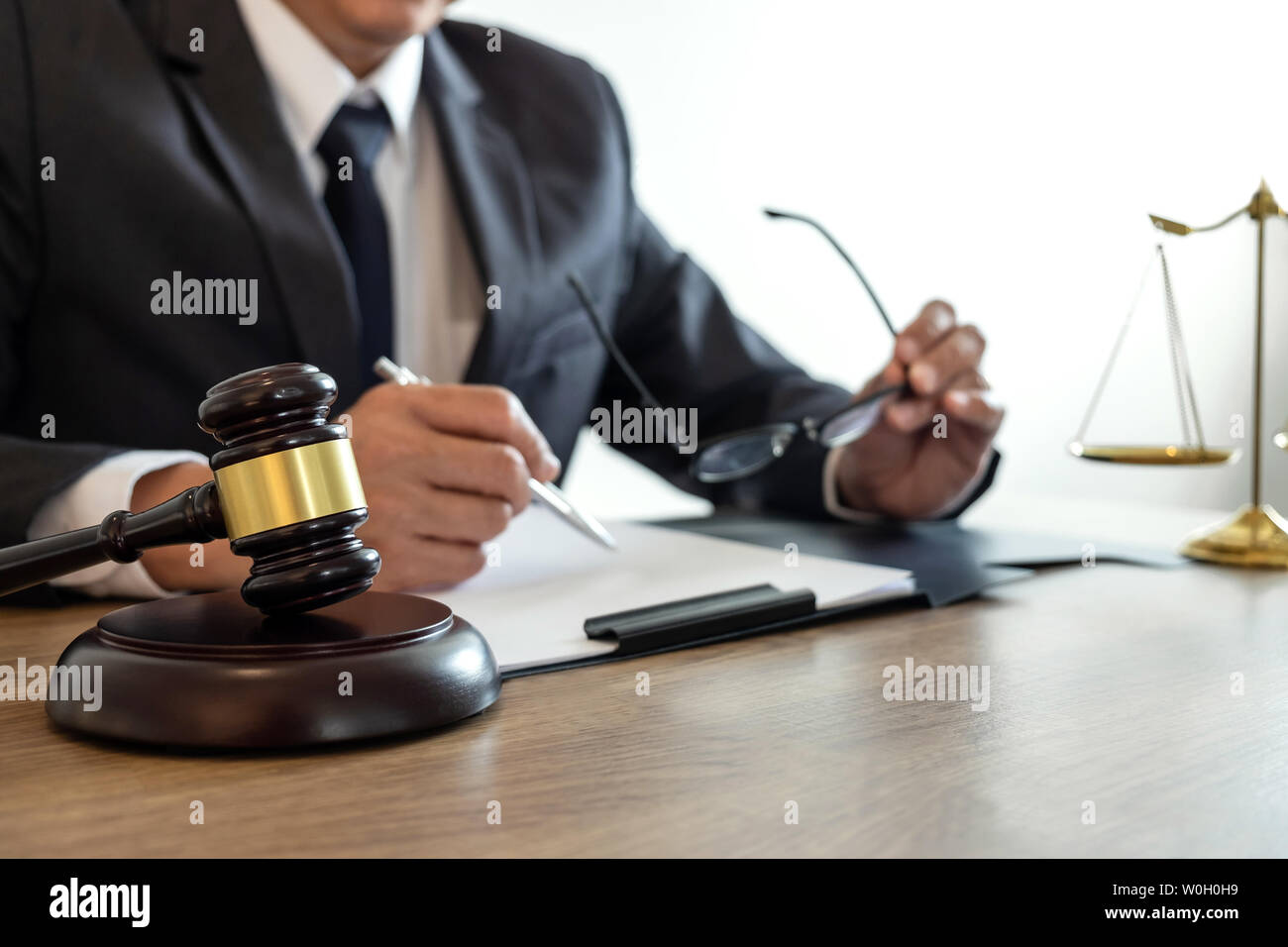 Law, lawyer attorney and justice concept, male lawyer or notary working on a documents and report of the important case in the law firm. Stock Photo