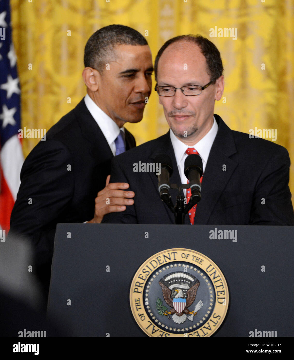 President Barack Obama (L) whispers to Thomas Perez after he nominated him to be the new Secretary of Labor at an event in the East Room of the White House in Washington, DC on March 18, 2013.  Perez is the present U.S. assistant attorney general heading the Justice Department's civil rights division, and if confirmed will take the position recently held by Hilda Solis, who resigned in January.   UPI/Pat Benic Stock Photo