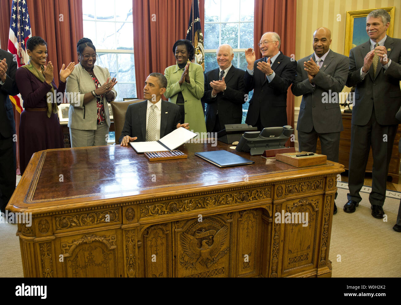 Guest applaud after President Barack Obama signed a bill designating the Harriet Tubman Underground Railroad, in Maryland, a National Monument during a bill signing ceremony in the Oval Office at the White House on March 25, 2013 in Washington, D.C. President Obama signed a series of bills designating five new National Monuments, including, Rio Grande del Norte, in New Mexico, the First State Monument in Delaware, the Harriet Tubman Underground Railroad in Maryland, the Charles Young Buffalo Soldiers in Ohio and the San Juan Islands in Washington. UPI/Kevin Dietsch Stock Photo
