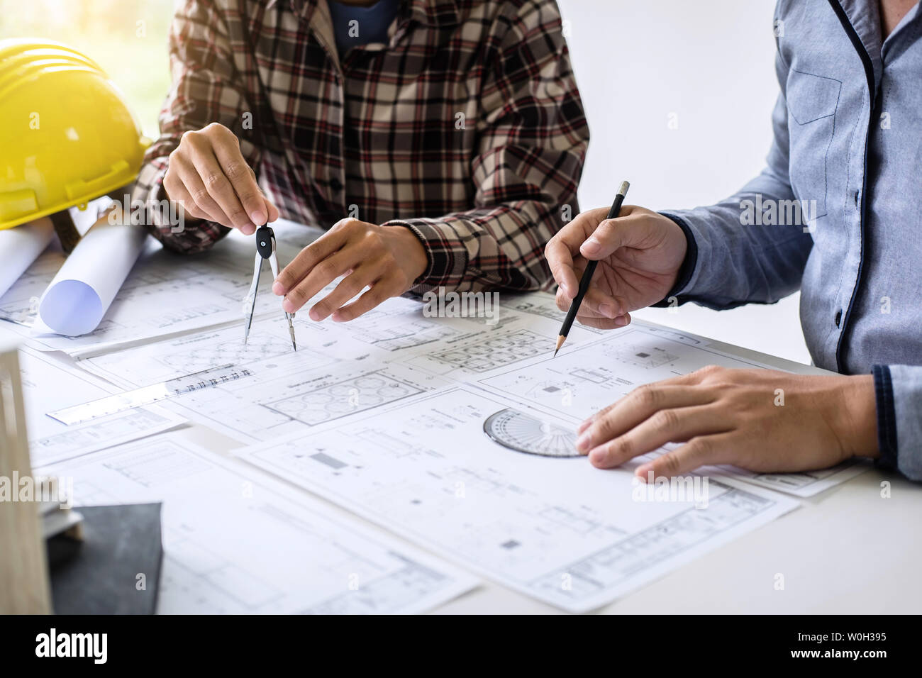 Construction engineering or architect discuss a blueprint while