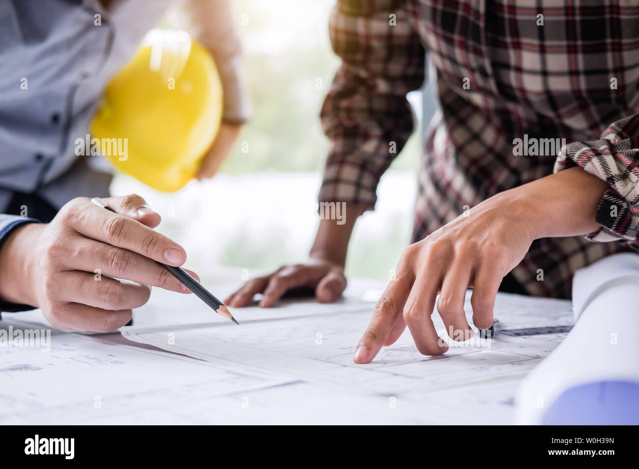 Construction engineering or architect discuss a blueprint while