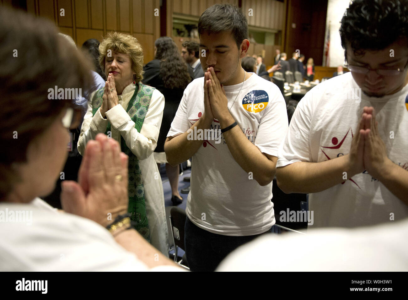 Members of the pro-immigration reform group Campaign for Citizenship hold a prayer vigil prior to the Senate Judiciary Committee mark-up of the Immigration Reform Bill, on Capitol Hill on May 9, 2013 in Washington, D.C.  UPI/Kevin Dietsch Stock Photo