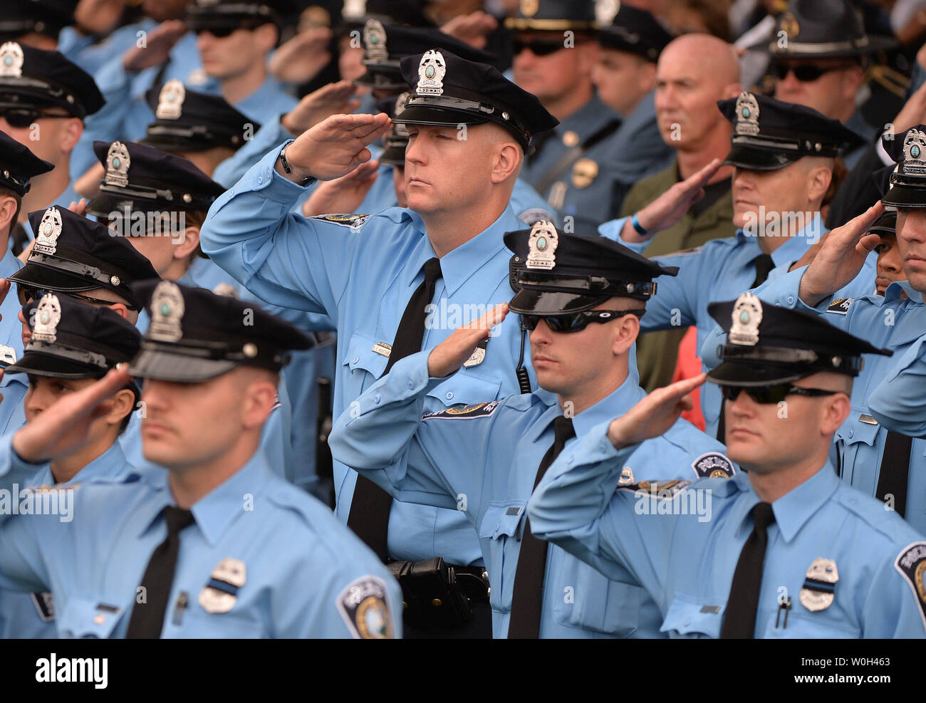 Law enforcement personnel salute during the National Anthem during the National Peace Officers' Memorial Service on the West Front of the Capitol Building on May 15, 2013 in Washington, D.C.  UPI/Kevin Dietsch Stock Photo