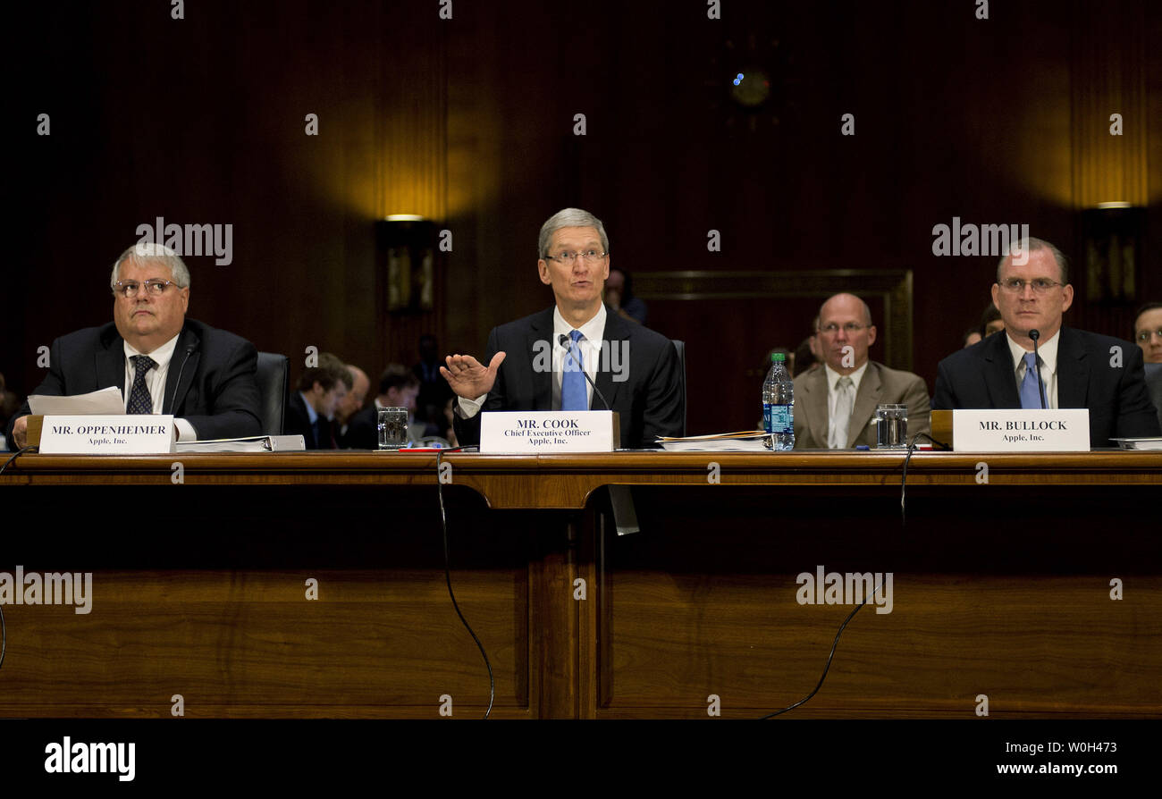 Timothy Cook (C), CEO of Apple Inc., Peter Oppenherimer (L), CFO of Apple Inc, and Phillip Bullock, Head of Tax Operations for Apple Inc. testify during a Senate Homeland Security and Governmental Affairs Subcommittee on Investigations hearing on Offshore Profit Shifting and the U.S. Tax Code, on Capitol Hill on May 21, 2013 in Washington, D.C.  UPI/Kevin Dietsch Stock Photo