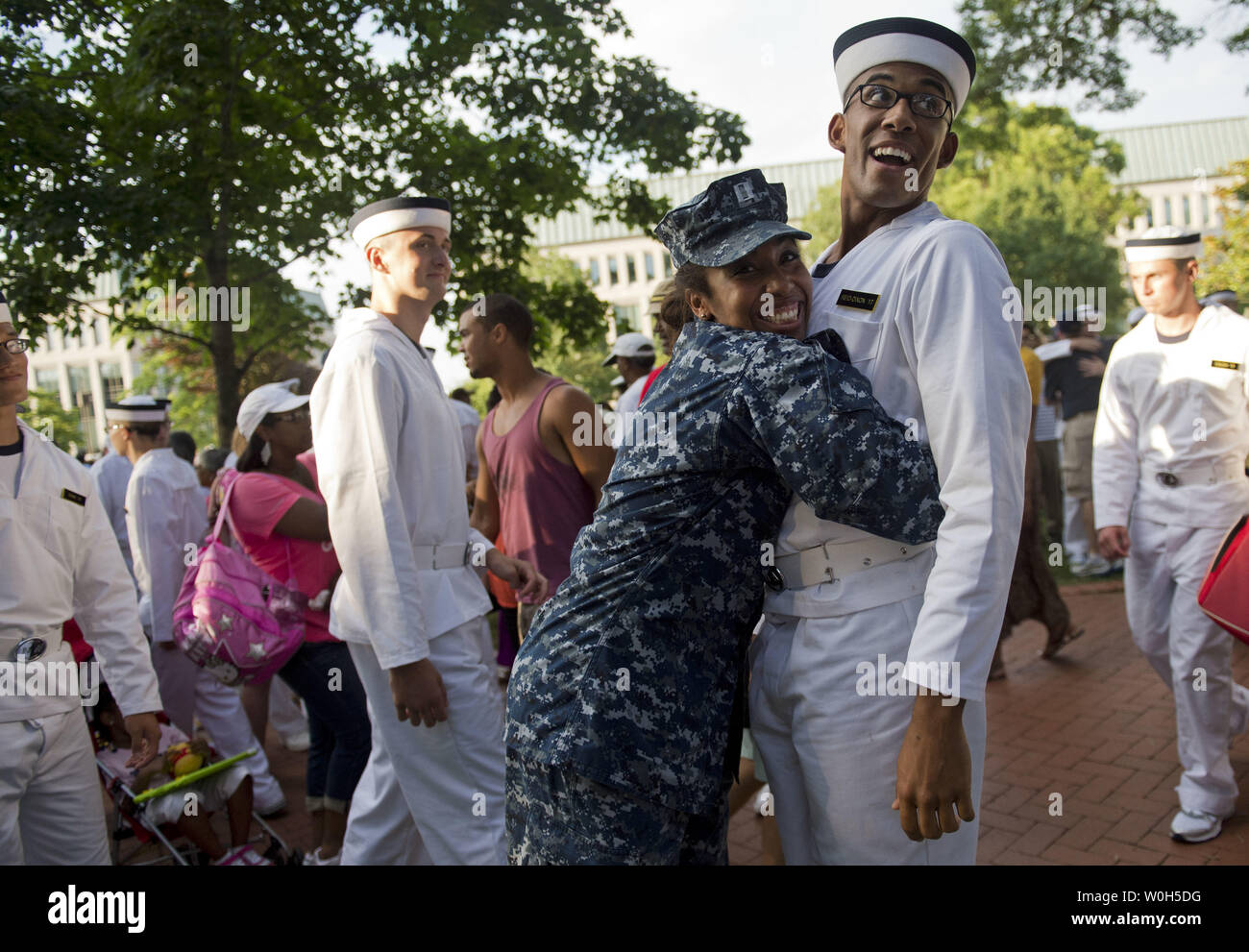 Navy Cpt. Erica Reid-Dixon (L) hugs her younger brother Jarred as he enters plebe summer at the end of Induction Day at the U.S. Naval Academy on June 27, 2013 in Annapolis, Maryland. The class of 2017 arrived at the Naval Academy to begin their summer training which will lay the foundation of the Academy's four-year professional curriculum.  UPI/Kevin Dietsch Stock Photo