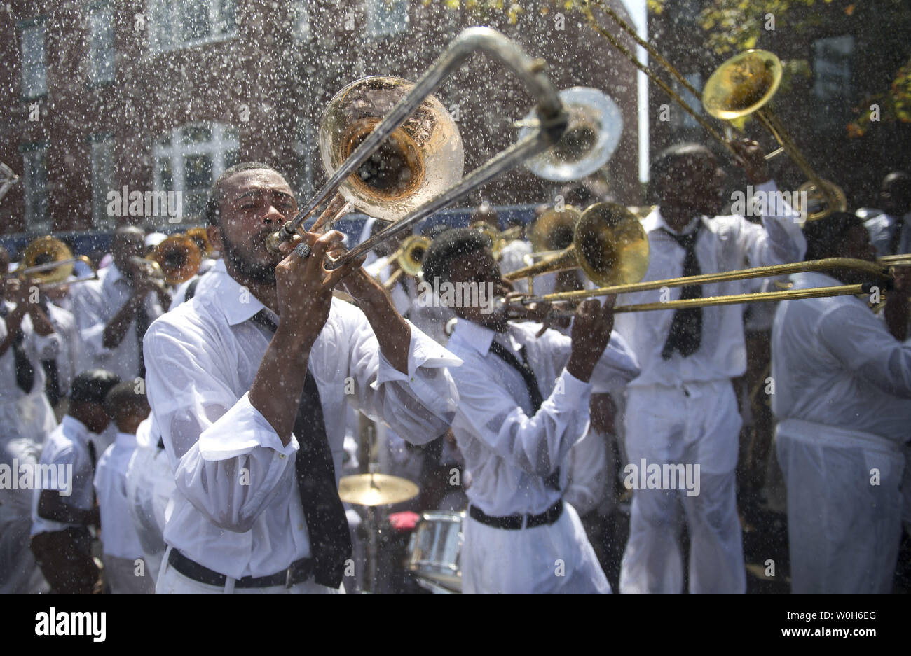 A band plays during a mass baptism by firehose at the United House of Prayer for All People on August 25, 2013 in Washington, D.C.  Hundreds of people gathered for the baptism following the church's 87th Annual Holy Convocation.  UPI/Kevin Dietsch Stock Photo