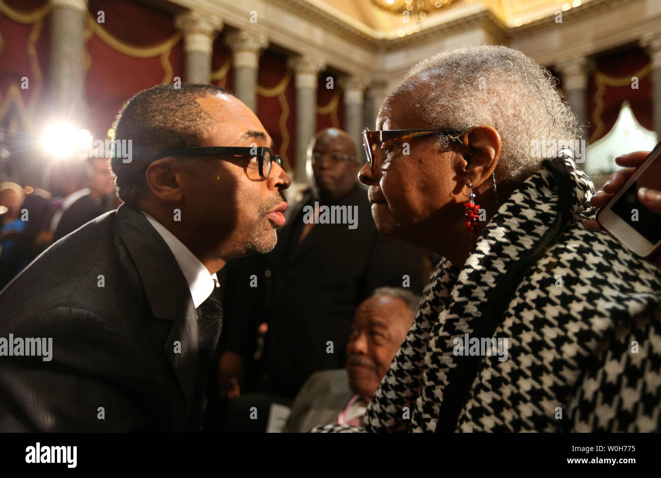 Film maker Spike Lee talks with Maxine McNair, mother of Denise McNair, victim of the 1963 Birmingham bombing, during a Congressional Gold Medal ceremony which was posthumously presented to victims of the bombing at the U.S. Capitol, in Washington on September 10, 2013.  The medal is awarded in recognition of victims Addie Mae Collins, Denise McNair, Carole Robertson and Cynthia Wesley, and how their sacrifice served as a catalyst for the Civil Rights Movement.   UPI/Molly Riley Stock Photo